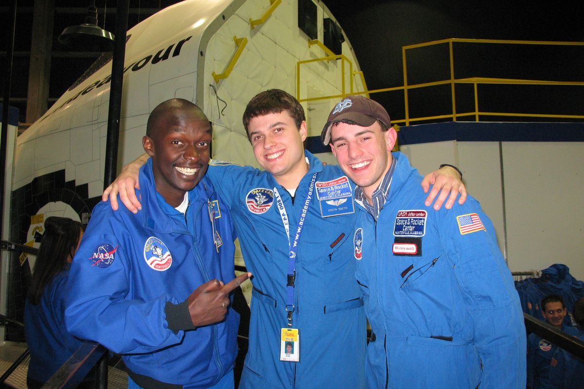 Corbin Croom, right, posed in a flight suit with Space Camp counselors who ran the mission control simulation.