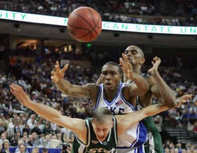 
Duke's DeMarcus Nelson, middle, fights for a loose ball with Michigan State's Crew Neitzel, front, and Alan Anderson during the second half of the Austin Regional semifinal. 
 (Associated Press / The Spokesman-Review)