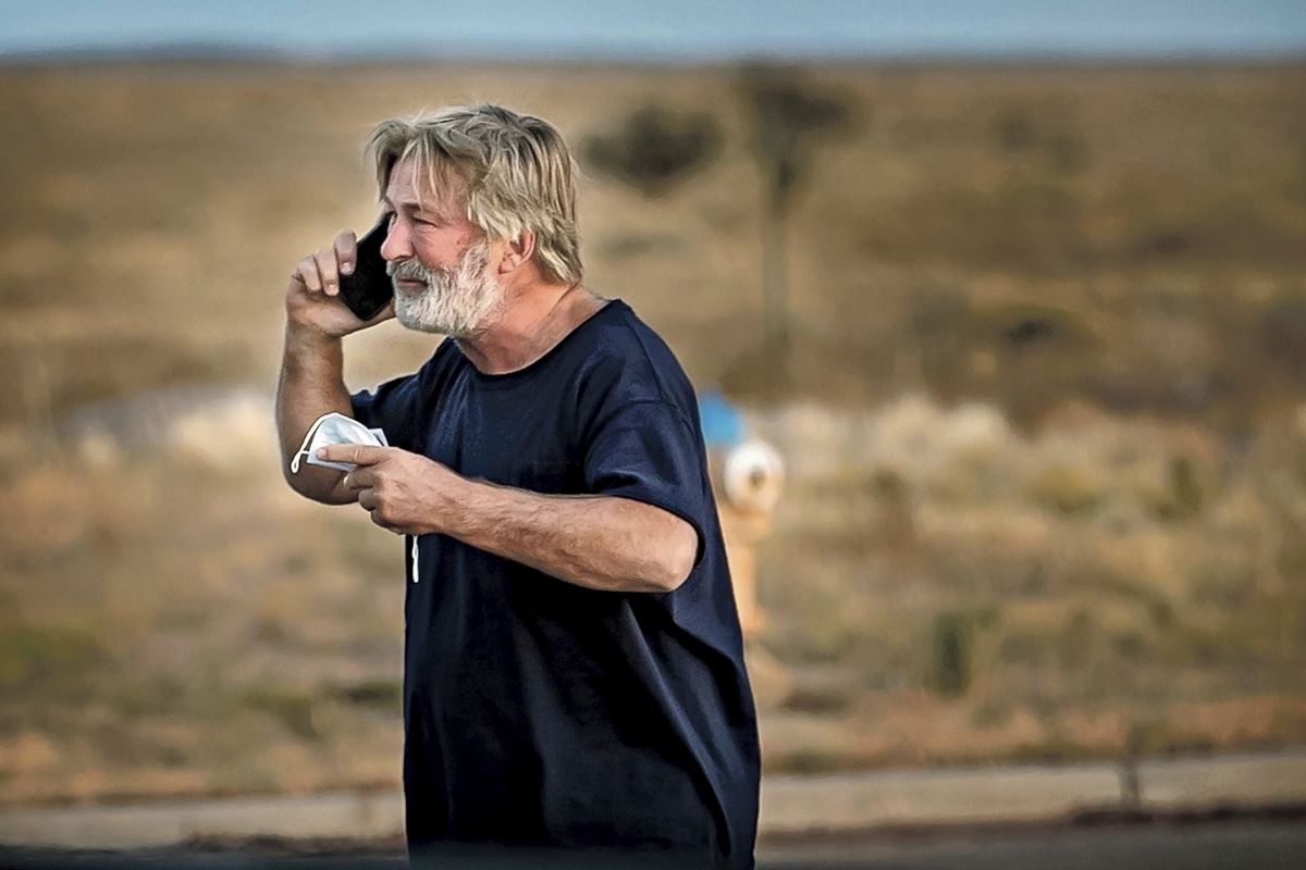 Alec Baldwin speaks on the phone in the parking lot outside the Santa Fe County Sheriff