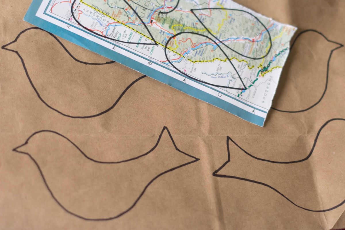 Trace and cut out a simple bird shape on a brown paper bag and a teardrop wing on a colorful paper scrap. (Katie Patterson Larson / For The Spokesman-Review)