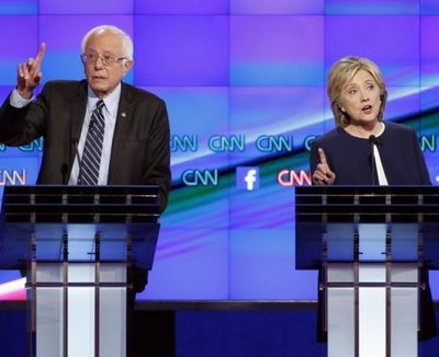 Hillary Rodham Clinton, right, and Sen. Bernie Sanders, of Vermont, speak during the CNN Democratic presidential debate Tuesday, Oct. 13, 2015, in Las Vegas. (AP Photo/John Locher)