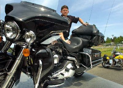 
Shumate Harley-Davidson General Manager Aric Muse helps offload a 2006 Harley-Davidson Ultra Classic at the Spokane dealership. 
 (Christopher Anderson / The Spokesman-Review)