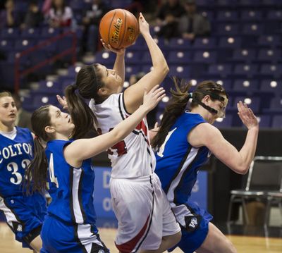 Colton's Kaitlin Druffel, left, and Mckenzie Heaslet, right, put the squeeze on Neah Bay's Rebecca Thompson during their quarterfinal game. (Colin Mulvany)