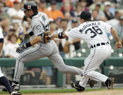 
Ichiro Suzuki is tagged by Detroit's John McDonald after getting caught in a rundown between second and third. 
 (Associated Press / The Spokesman-Review)