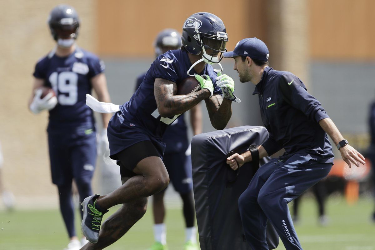 Seattle Seahawks wide receiver Brandon Marshall, center, runs a drill during  practice May 30 in Renton, Wash. (Ted S. Warren / AP)