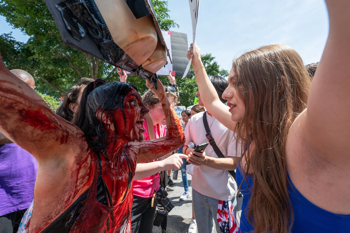 Anti-abortion activist Elianna Geertgens, right, argues with abortion rights activist Sam Scarcello outside of the Supreme Court on Independence Day.   (Craig Hudson/For The Washington Post)