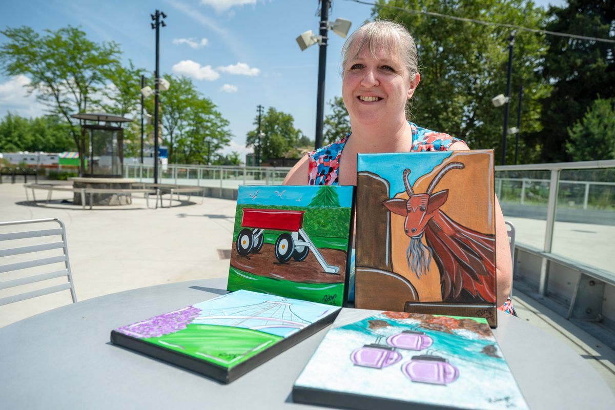 Artist Robyn Smith, shown with some of her whimsical paintings of Spokane scenes, will give lessons on painting Riverfront Park icons for a Spokane Parks class.  (Jesse Tinsley/The Spokesman-Review)