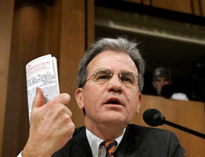 
Senate Judiciary Committee member Sen. Tom Coburn, R-Okla., holds a copy of the U.S. Constitution. Associated Press
 (Associated Press / The Spokesman-Review)