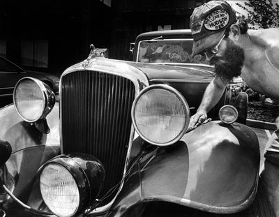 1985 - Buffed by a buff: Dick Riggs polishes up the shine on his 1933 Terraplane 8 that he and his wife Phyllis drove to Spokane from Portland for this weekend' 17th annual Hudson, Essex and Terraplane Club meet at Cavanaugh's River Inn. More than 80 autos will be on display at the meet which runs through Sunday.  (Chris Anderson / Photo Archive  Spokesman Review)