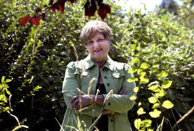 
Jan Kruger does calligraphy and creates books, greeting cards, journals and one-of-a-kind art pieces. Kruger poses for a portrait in her backyard. 
 (The Spokesman-Review)