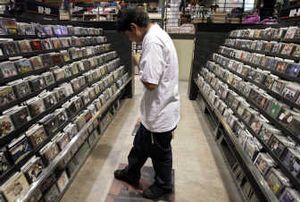 
Gaston Chabolla, 15, searches for CDs at a music store in Los Angeles. Major recording labels are under pressure to explore new ways to get music fans to pay for music. Associated Press
 (Associated Press / The Spokesman-Review)