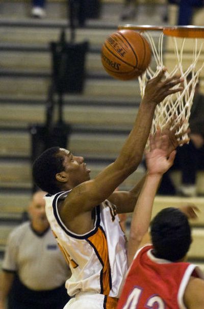 
West Valley's E.J. Richardson (54) gets a close-in basket during the 3A playoff game Tuesday with West Valley of Yakima. The Eagles won 58-38.
 (Christopher Anderson / The Spokesman-Review)
