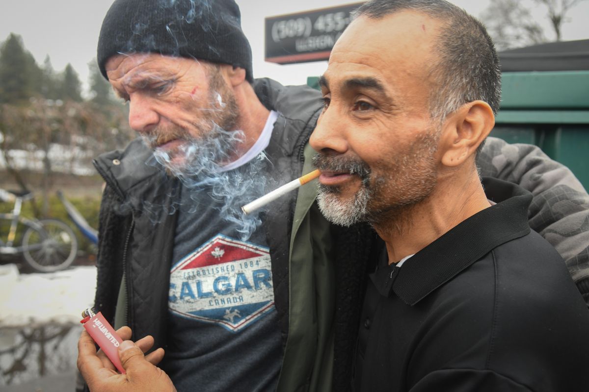 Clifford Moore, 47, left, and ose Chavez, 52, share a few moments together outside Jewels Helping Hands on Cannon Street, Feb. 6, 2020. (Dan Pelle / The Spokesman-Review)