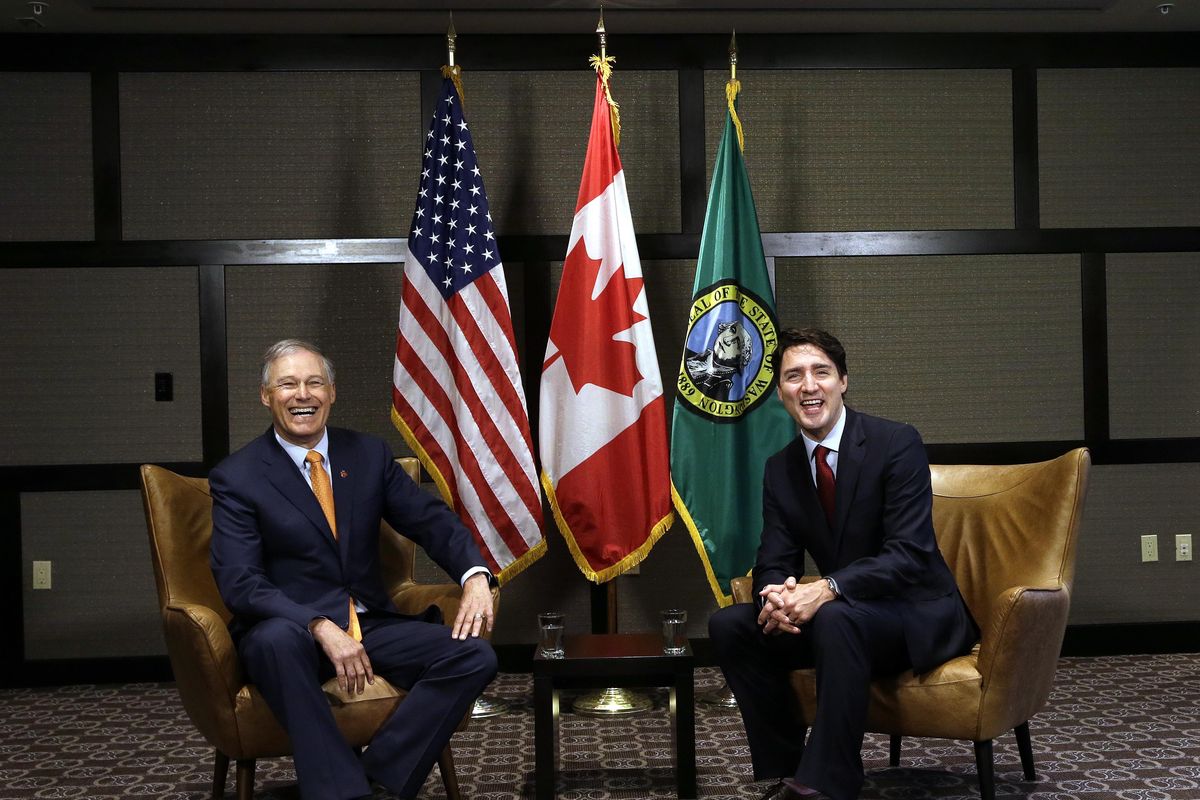 Canada Prime Minister Justin Trudeau, right, and Washington state Gov. Jay Inslee share a laugh as they pose for photographers before a meeting Thursday, May 18, 2017, in Seattle. (Elaine Thompson / Associated Press)