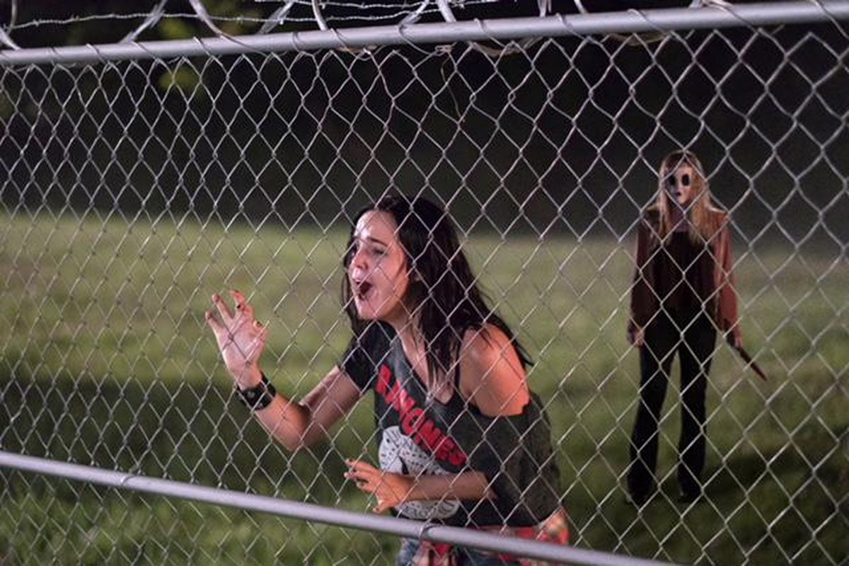 Kinsey (Bailee Madison) tries to escape from Dollface (Emma Bellomy) in “The Strangers: Prey at Night.” (Brian Dogulas / Aviron Pictures)