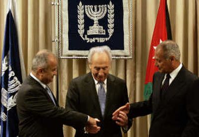 
Israeli President Shimon Peres, center, joins hands with Egyptian Foreign Minister Ahmed Aboul Gheit, right, and Jordan's Foreign Minister Abdul-Ilah Khatib in Jerusalem on Wednesday.Associated Press
 (Associated Press / The Spokesman-Review)