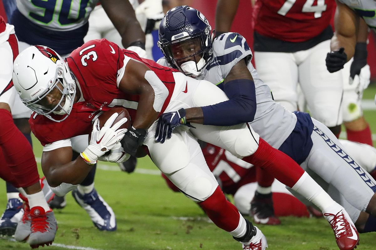 Arizona Cardinals running back David Johnson  is tackled by Seattle Seahawks cornerback Tre Flowers during the first half Sept. 30 in Glendale, Ariz. (Rick Scuteri / AP)