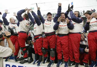 
Buddy Rice's team reacts on the pit wall as Rice wins the Indy 500 at Indianapolis Motor Speedway on Sunday. 
 (Associated Press / The Spokesman-Review)