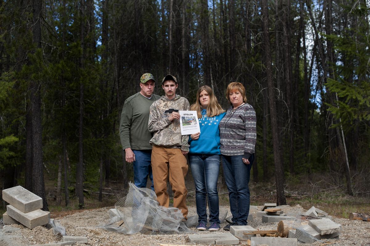 Moose Hempel, left, and his family, Tyler, Kayla and wife Chris, arrived at their cabin site in a forest north of Springdale, Wash., Tuesday to find the structure had been stolen. The cabin, measuring 10 feet by 20 feet, was lifted from its foundation sometime after March 21. (Tyler Tjomsland)