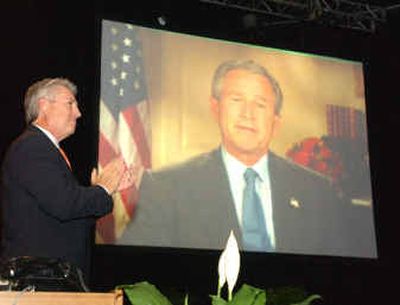 
Dr. Jack Graham, outgoing president of the Southern Baptist Convention, applauds a video address by President George W. Bush at the annual meeting of the Southern Baptist Convention at the Indiana Convention Center in Indianapolis last month. 
 (Associated Press / The Spokesman-Review)