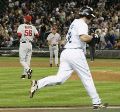 Angels pitcher Jered Weaver turns his back as Chris Snelling rounds the bases after hitting a solo home run in the first inning. 
 (Associated Press / The Spokesman-Review)