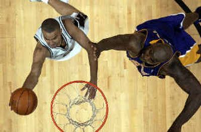 
San Antonio guard Tony Parker (9) drives to the goal against Los Angeles' Shaquille O'Neal.San Antonio guard Tony Parker (9) drives to the goal against Los Angeles' Shaquille O'Neal.
 (Associated PressAssociated Press / The Spokesman-Review)