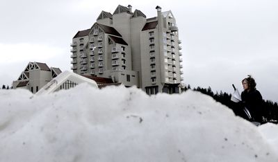 The snow mounds were still high surrounding the Coeur d’Alene Resort on Thursday. Hotels say snow days hurt, but the season is typically slow anyway.  (Kathy Plonka / The Spokesman-Review)