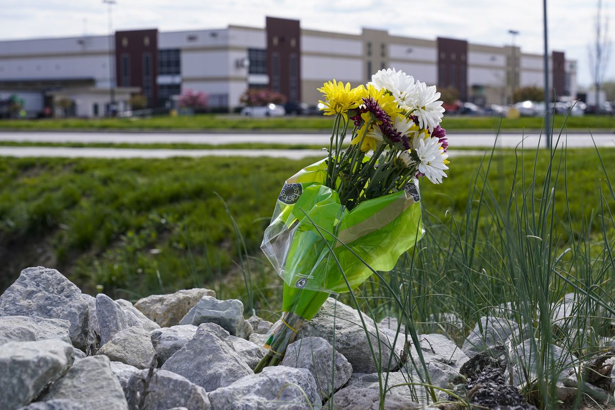A single bouquet of flower sits in the rocks across the street from the FedEx facility in Indianapolis, Saturday, April 17, 2021 where eight people were shot and killed. A gunman killed eight people and wounded several others before apparently taking his own life in a late-night attack at a FedEx facility near the Indianapolis airport, police said, in the latest in a spate of mass shootings in the United States after a relative lull during the pandemic.  (Michael Conroy)