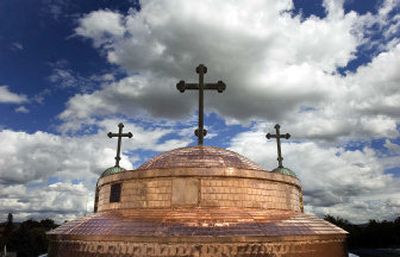 The Holy Trinity Greek Orthodox Church on North Monroe Street is getting a copper roof by BJ Roofing. The roof, which may last 200 years or more, will have the typical green finish in about 30 years, according to BJ Roofing employees Jeff White and Brad Foster. 
 (Jed Conklin / The Spokesman-Review)
