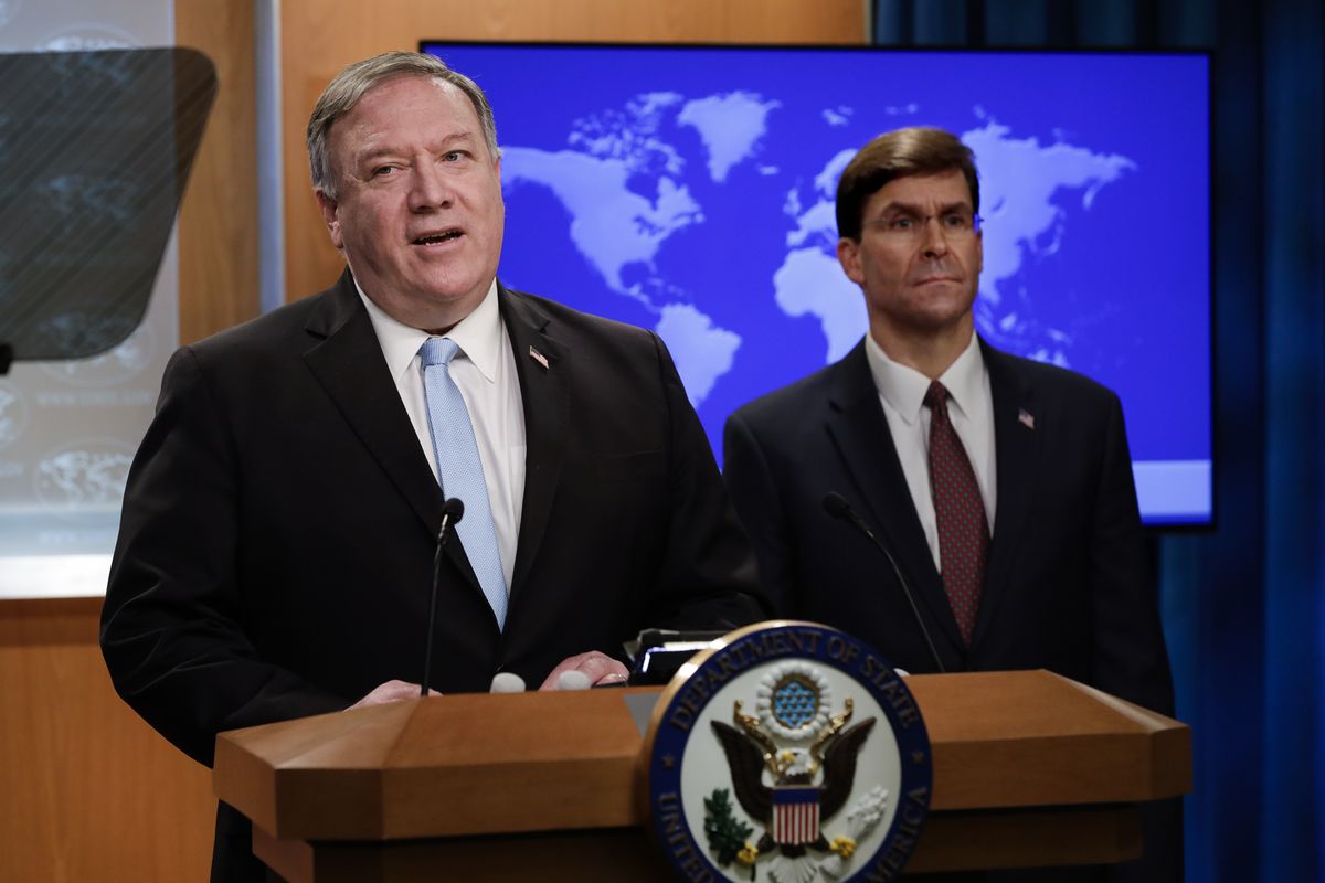 Secretary of State Mike Pompeo speaks as Defense Secretary Mark Esper listens, during a joint briefing, Thursday, June 11, 2020 at the State Department in Washington, on an executive order signed by President Donald Trump aimed at the International Criminal Court. Trump has lobbed a broadside attack against the International Criminal Court. He