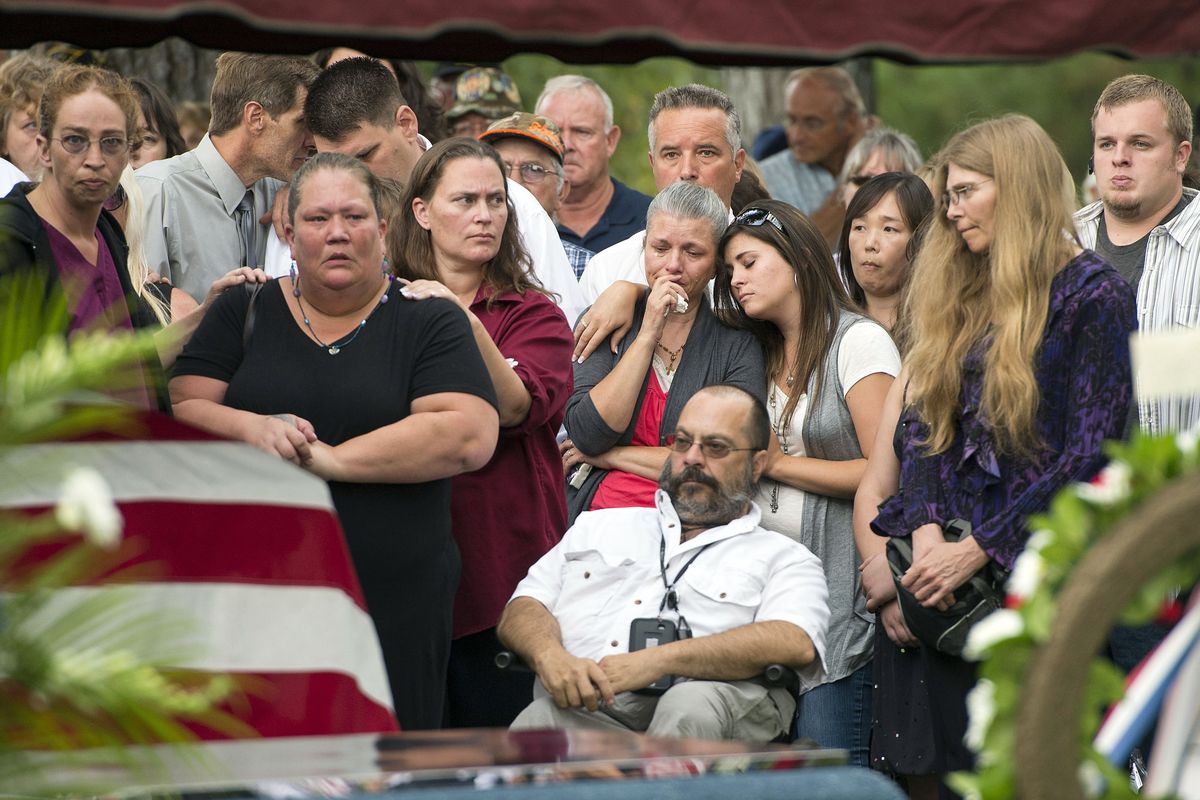 With hundreds in attendance, Spokane veteran Delbert Belton is buried with full military honors during a service at Greenwood Memorial Terrace on Thursday. (Colin Mulvany)