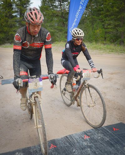 In this April 30, 2016 photo, a weary and mud-spattered Eddie Joy, left, and Kristine Akland finish the Missoula Hell Ride, an 83-mile gravel race, in just over five hours in the hills outside Missoula, Montana. Due to wet weather, this year's race was even more hellish than usual. (Associated Press)