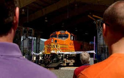 
Burlington Northern and Santa Fe Railway Co. used one of its trains to cut through a ribbon during the official opening of its $42 million fueling facility at Hauser on Monday.
 (Kathy Plonka / The Spokesman-Review)