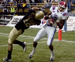 ORG XMIT: IDMOS101 Louisiana Tech receiver Cruz Williams, right, fights to control a catch for a touchdown while defended by Idaho cornerback Aaron Grymes, left, during the first quarter of an NCAA college football game Saturday, Oct. 31, 2009, at the Kibbie Dome in Moscow, Idaho. Williams controlled the ball for a touchdown. Idaho won 35-34. (AP Photo/Moscow-Pullman Daily News, Dean Hare) (Dean Hare / The Spokesman-Review)