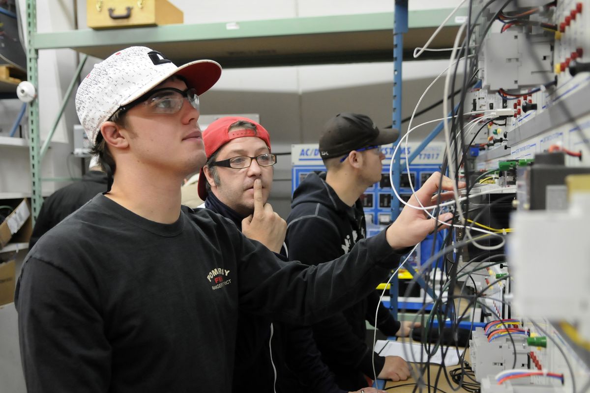Walla Walla Community College Wind Technology students Matt Powell, left, and Eric Morin, center, team up to work on an automated controls assignment during class on Nov. 14. Employment prospects are high for graduates of the program.