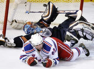 Rangers' Chris Drury bowls over Oilers goalie Mathieu Garon.Associated Press
 (Associated Press / The Spokesman-Review)