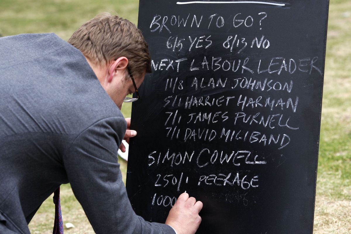 Bookmaker Robin Hutchison writes down the betting odds Friday for the next Labour Party leader on a blackboard outside the Houses of Parliment in London.  (Associated Press / The Spokesman-Review)