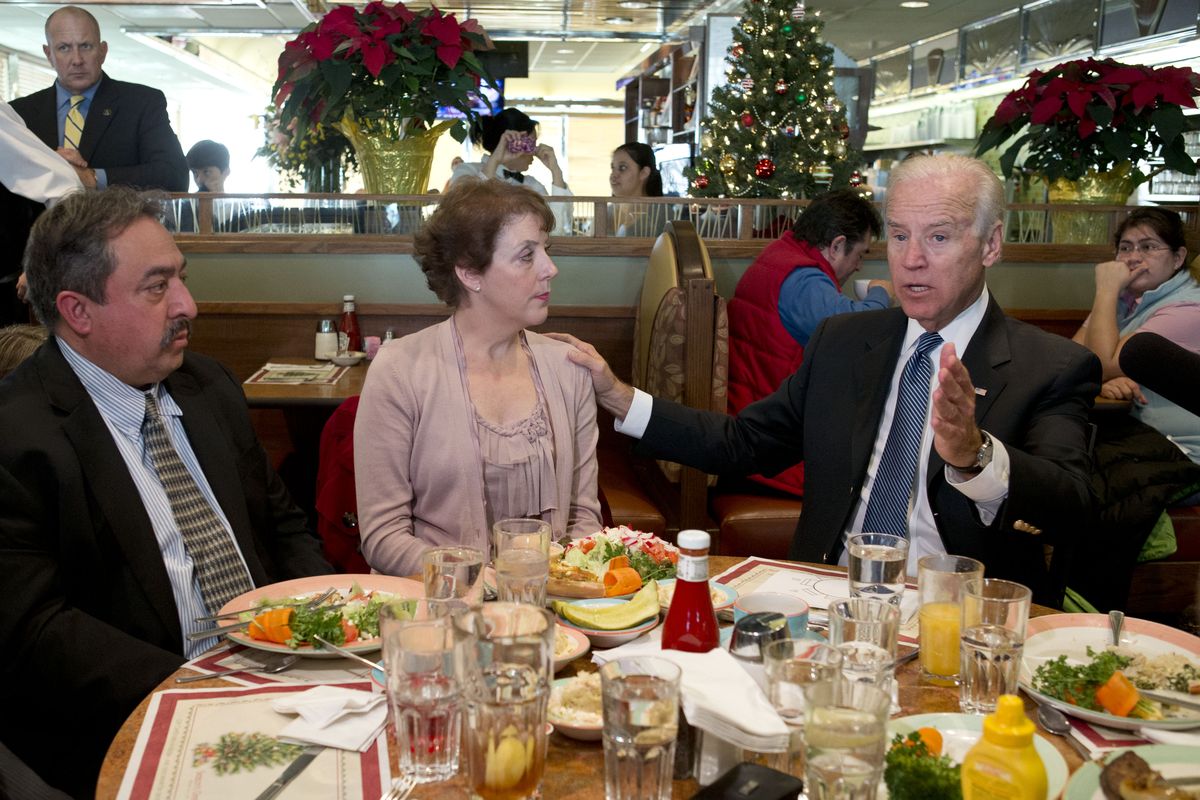 Vice President Joe Biden, right, speaks to the media after eating lunch with middle class tax-payers including Fernando Garavito, of North Potomac, Md., left, Anne Marie Munos, of Falls Church, Va., Friday, Dec. 7, 2012, at the Metro 29 diner in Arlington, Va. (Jacquelyn Martin / Associated Press)