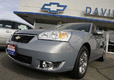 
An unsold 2007 Chevrolet Malibu sedan sits in front of a Chevrolet dealership in Loveland, Colo. 
 (Associated Press / The Spokesman-Review)