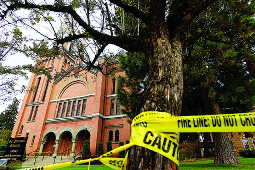 Caution tape forms a perimeter around St. Thomas church in Coeur d'Alene on Friday. Some of the tiles adorning the steeple of the church have fallen off and the area has been temporarily barricaded as a safety precaution due to falling debris. (Shawn Gust/press)