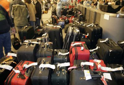 
Unclaimed bags stack up at Denver's airport.  
 (Associated Press / The Spokesman-Review)