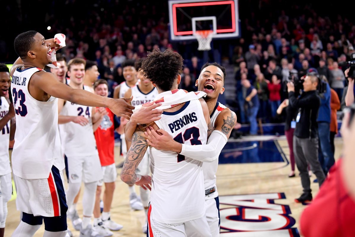 Gonzaga Bulldogs guard Josh Perkins (13) is embraced by Gonzaga Bulldogs guard Geno Crandall (0) after defeating BYU during the second half of a college basketball game on Saturday, February 23, 2019, at McCarthey Athletic Center in Spokane, Wash. Gonzaga won the game 102-68. (Tyler Tjomsland / The Spokesman-Review)