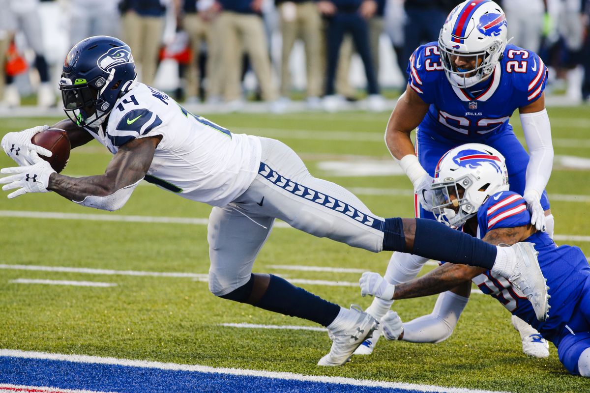Seattle Seahawks’ DK Metcalf (14) dives for a touchdown as Buffalo Bills’ Dane Jackson (30) attempts to tackle him during the second half of an NFL football game Sunday, Nov. 8, 2020, in Orchard Park, N.Y.  (Jeffrey T. Barnes)