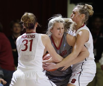 WSU guard Jordan Kelley, center, is closely guarded by Stanford’s Toni Kokenis and Joslyn Tinkle. (Associated Press)