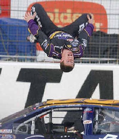 Carl Edwards does a backflip from his car after winning the NASCAR Busch Aarons 312 on Saturday.
(Associated Press / The Spokesman-Review)