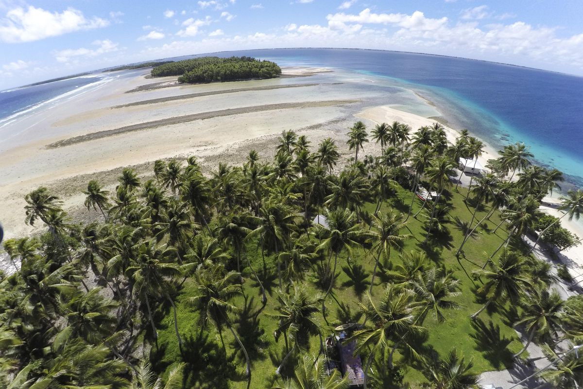 This Nov. 6, 2015, file photo, shows a large section of land between the trees washed away due to continuing rising sea leaves on Majuro Atoll, the capital of the Marshall Islands. Small island nations are using the weeklong gathering of world leaders at this years U.N. General Assembly to highlight the one issue that threatens all of their existence: global warming. On the map, their homes are tiny specks in a vast sea of blue, rarely in the headlines and far removed from the centers of power. But for a few days each year, the leaders of small island nations share the same podium as presidents and prime ministers from the worlds most powerful nations, and their message is clear: global warming is already changing our lives, and it will change yours too. (Rob Griffith / Associated Press)