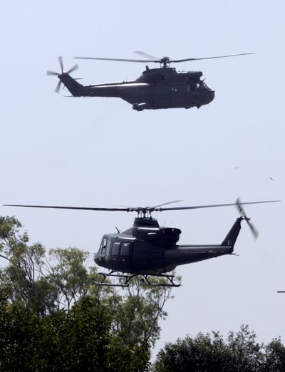 Pakistani army helicopters fly over army headquarters after an attack by gunmen Saturday in Rawalpindi.  (Associated Press / The Spokesman-Review)