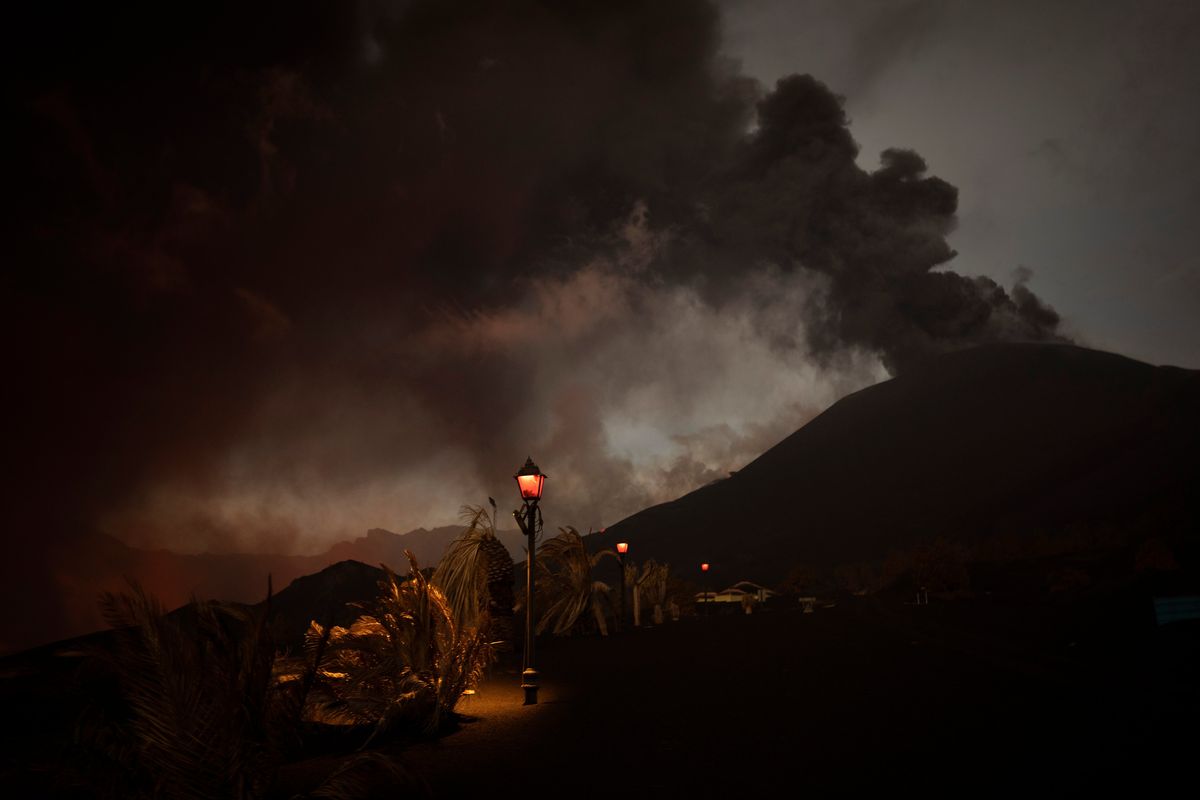 FILE - Ash covers the streets and houses in Las Manchas village as lava flows from the volcano, on the Canary island of La Palma, Spain, Dec. 6 2021. A volcanic eruption in Spain’s Canary Islands shows no sign of ending after 85 days. It became the island of La Palma’s longest eruption on record on Sunday, Dec. 12. (Emilio Morenatti)