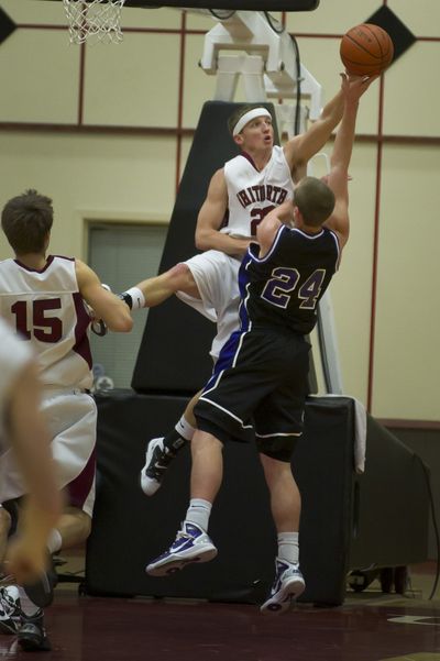 Whitworth’s Clay Gebbers blocks a shot by Linfield’s Zach Anderson in the first half of Friday’s game. (Colin Mulvany)
