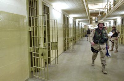 
U.S. soldiers patrol the Abu Ghraib prison outside Baghdad, Iraq, in this May 2004 photograph. The U.S. military said Thursday that it will return control of the facility to Iraqi authorities soon
 (Associated Press / The Spokesman-Review)